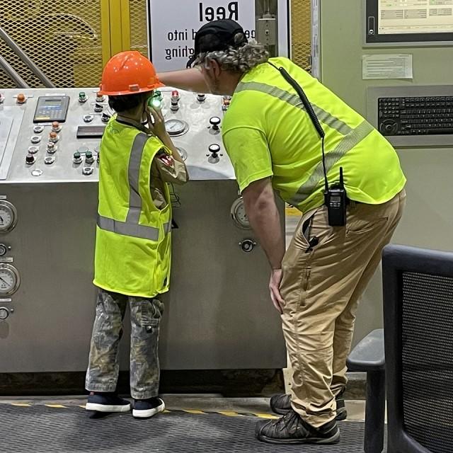 Cedar River, Iowa Boy Scout helps to push a button in a facility